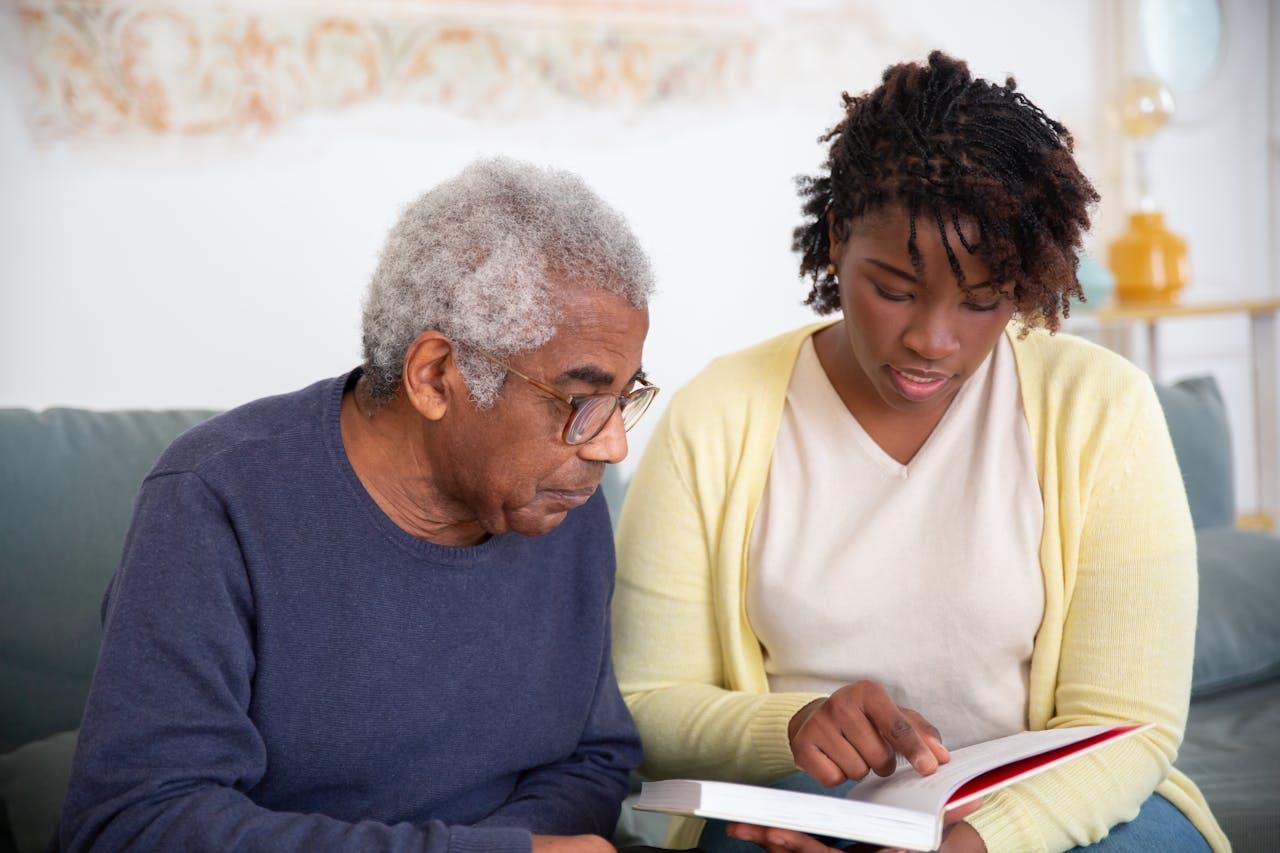 Image of a elderly man and a woman going over a reading material